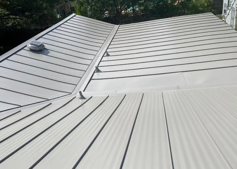 Solar attic fan installed on a metal roof for Roof Ventilation in Scriba